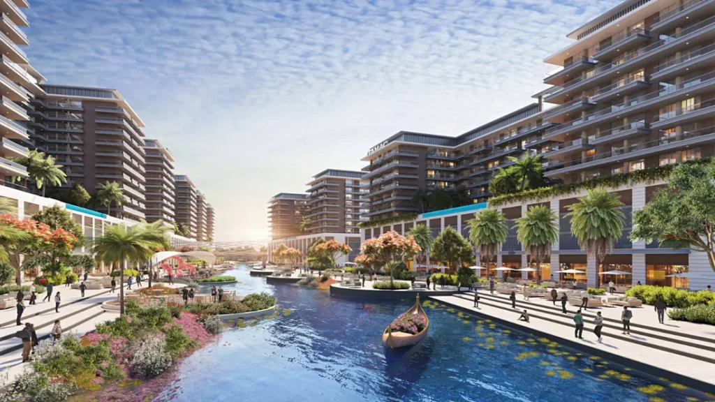 DAMAC Lagoons Venice canal promenade with gondola flowering gardens and low-rise apartments — Dubai investment properties